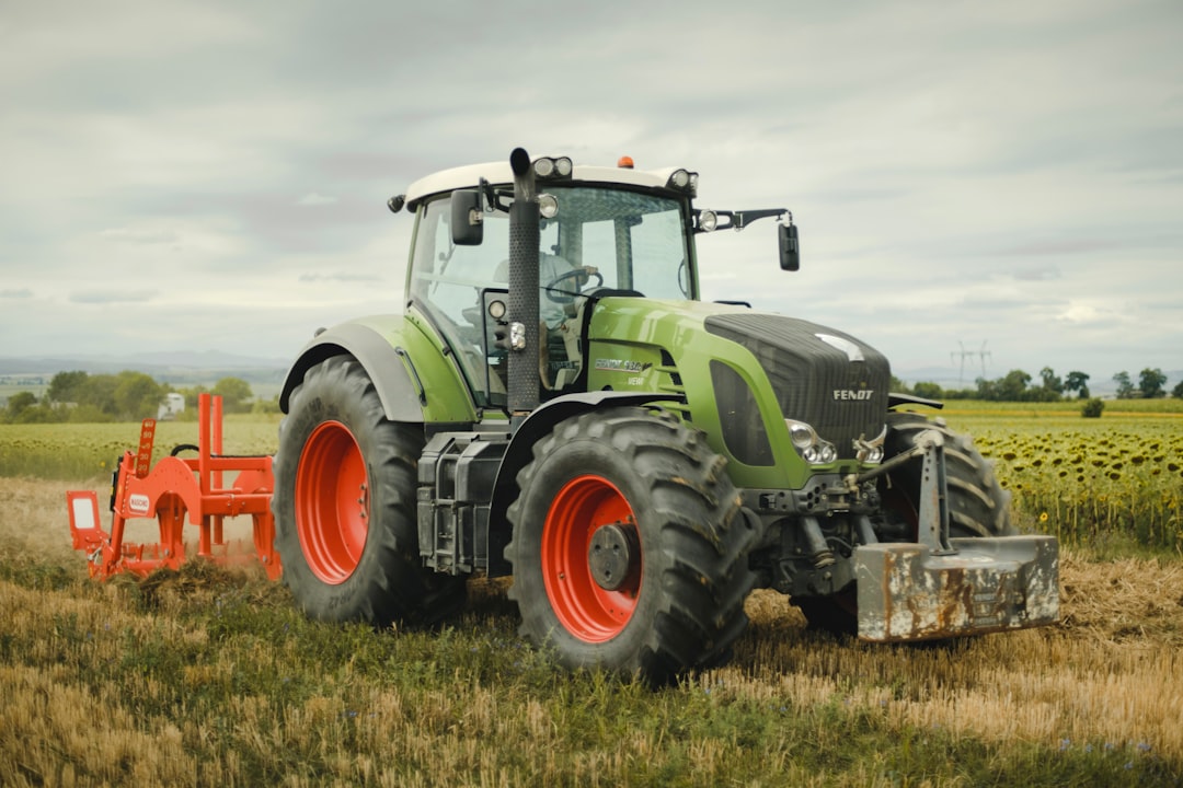 Photo by Teo Sticea a tractor in a field