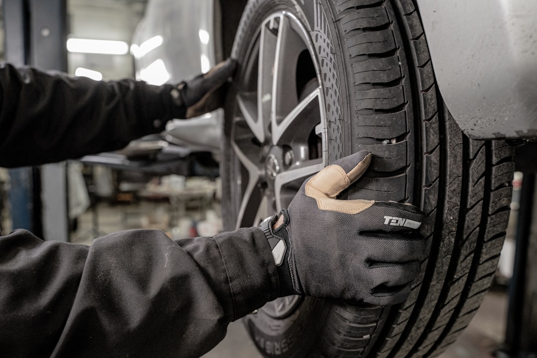 Photo by Jimmy Nilsson Masth a man working on a tire in a garage